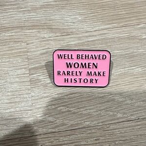 Pink enamel pin with the quote 'Well Behaved Women Rarely Make History'.